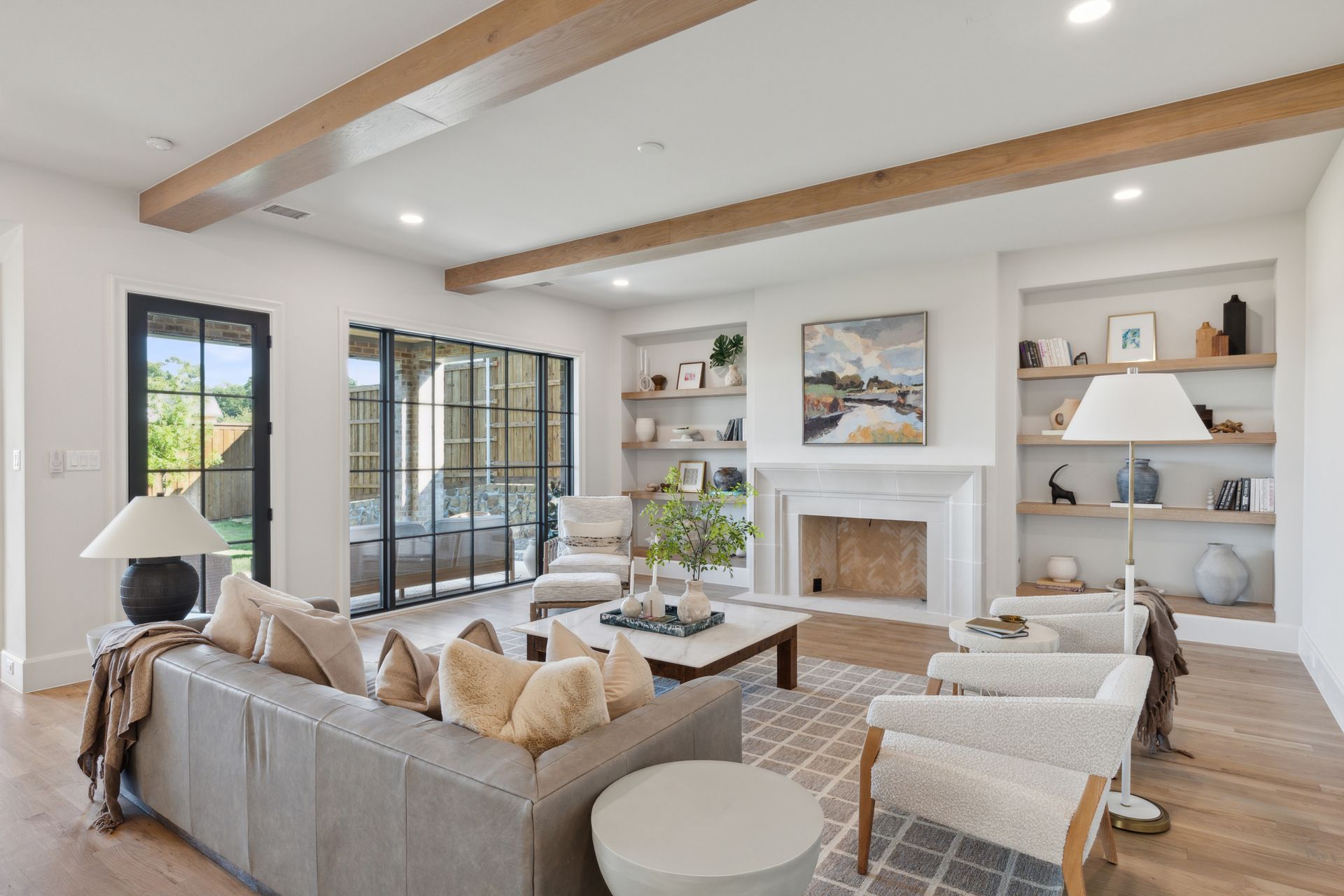 A living room with a couch , chairs , coffee table and fireplace.