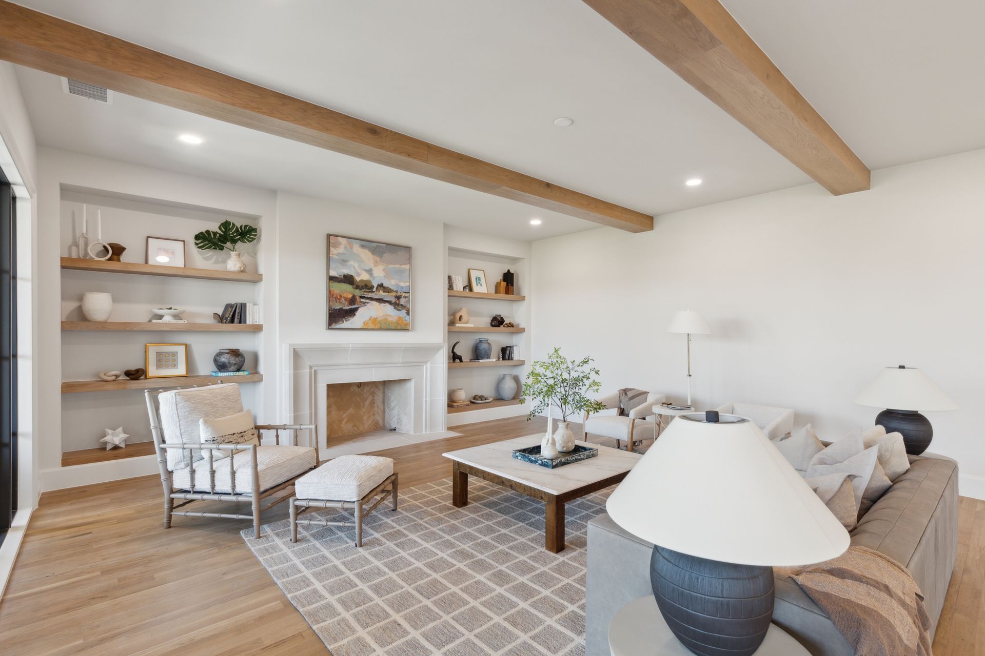 A living room with a couch , chair , coffee table and fireplace.
