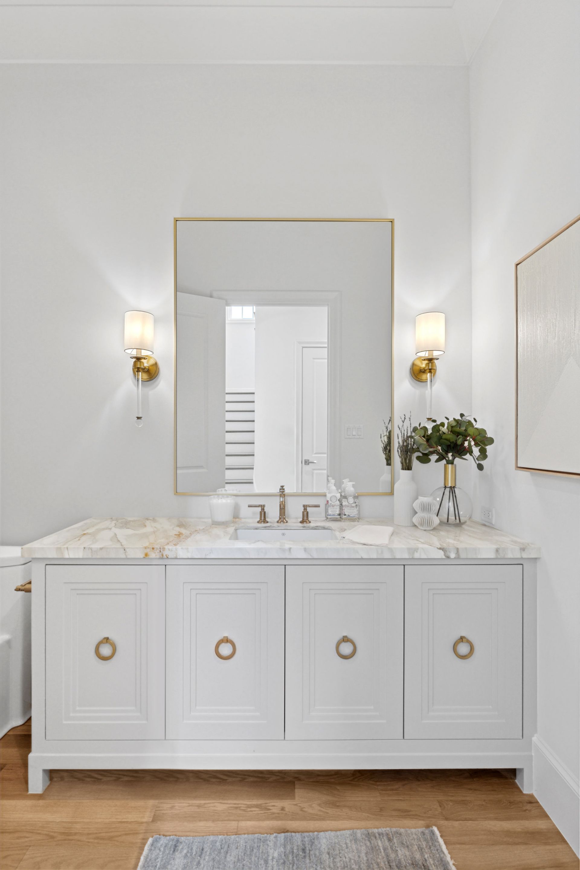 A bathroom with a sink , mirror , and cabinets.