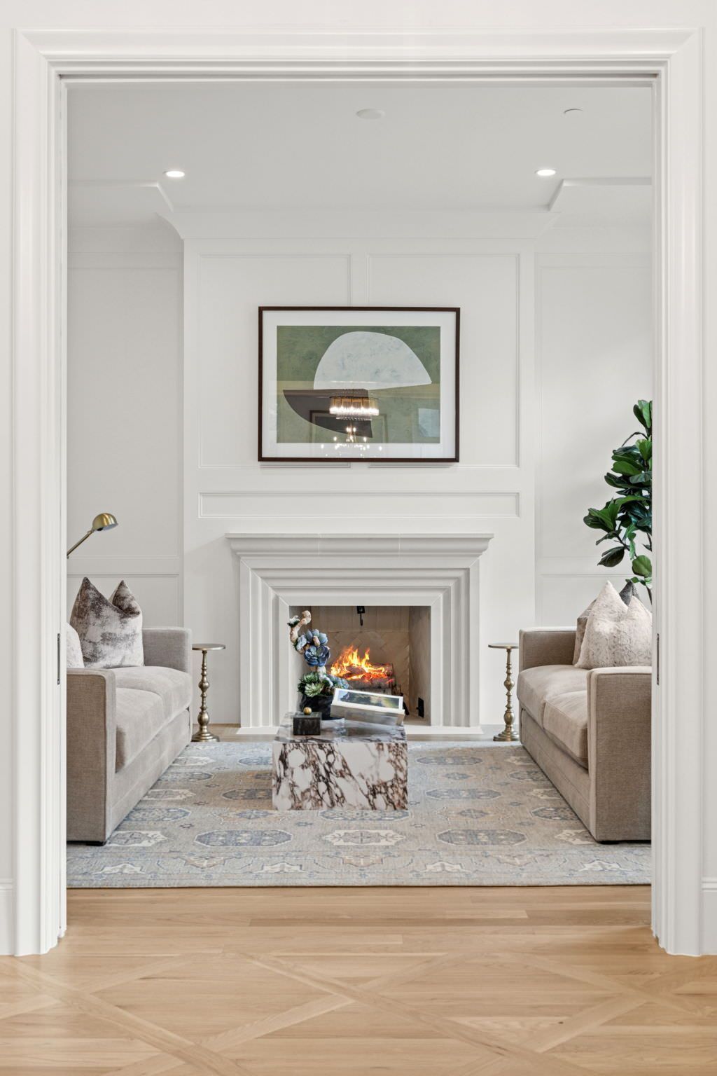 A living room with two couches and a fireplace.