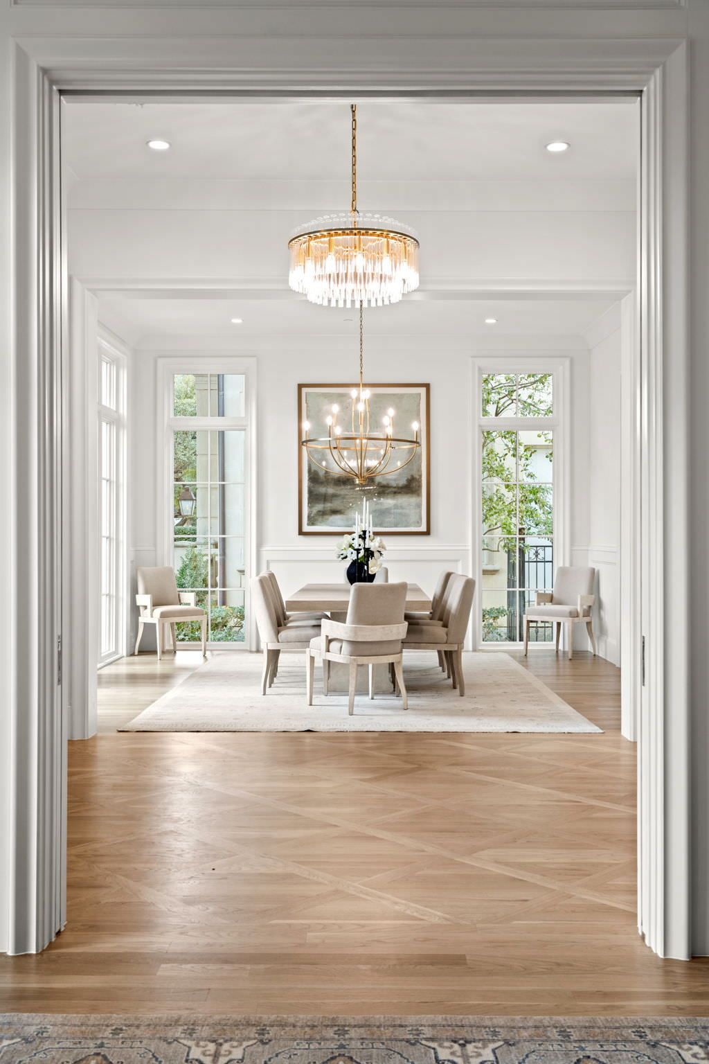 A dining room with a table and chairs and a chandelier.