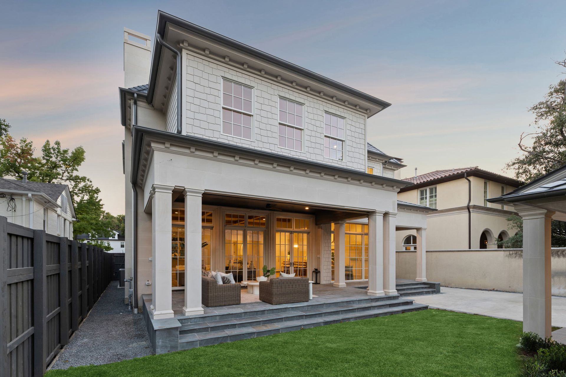 A large white house with a large lawn in front of it