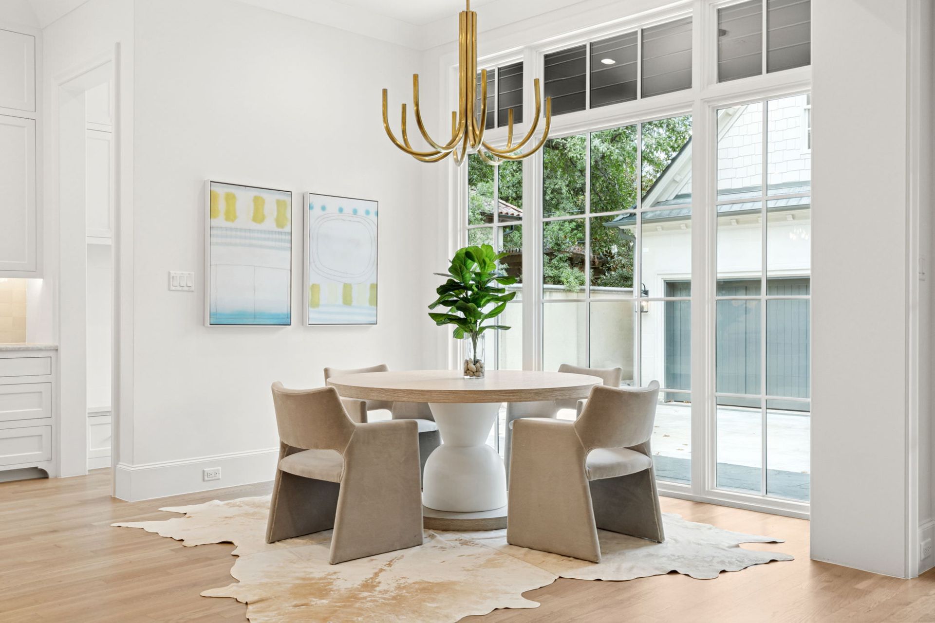 A dining room with a table and chairs and a rug.