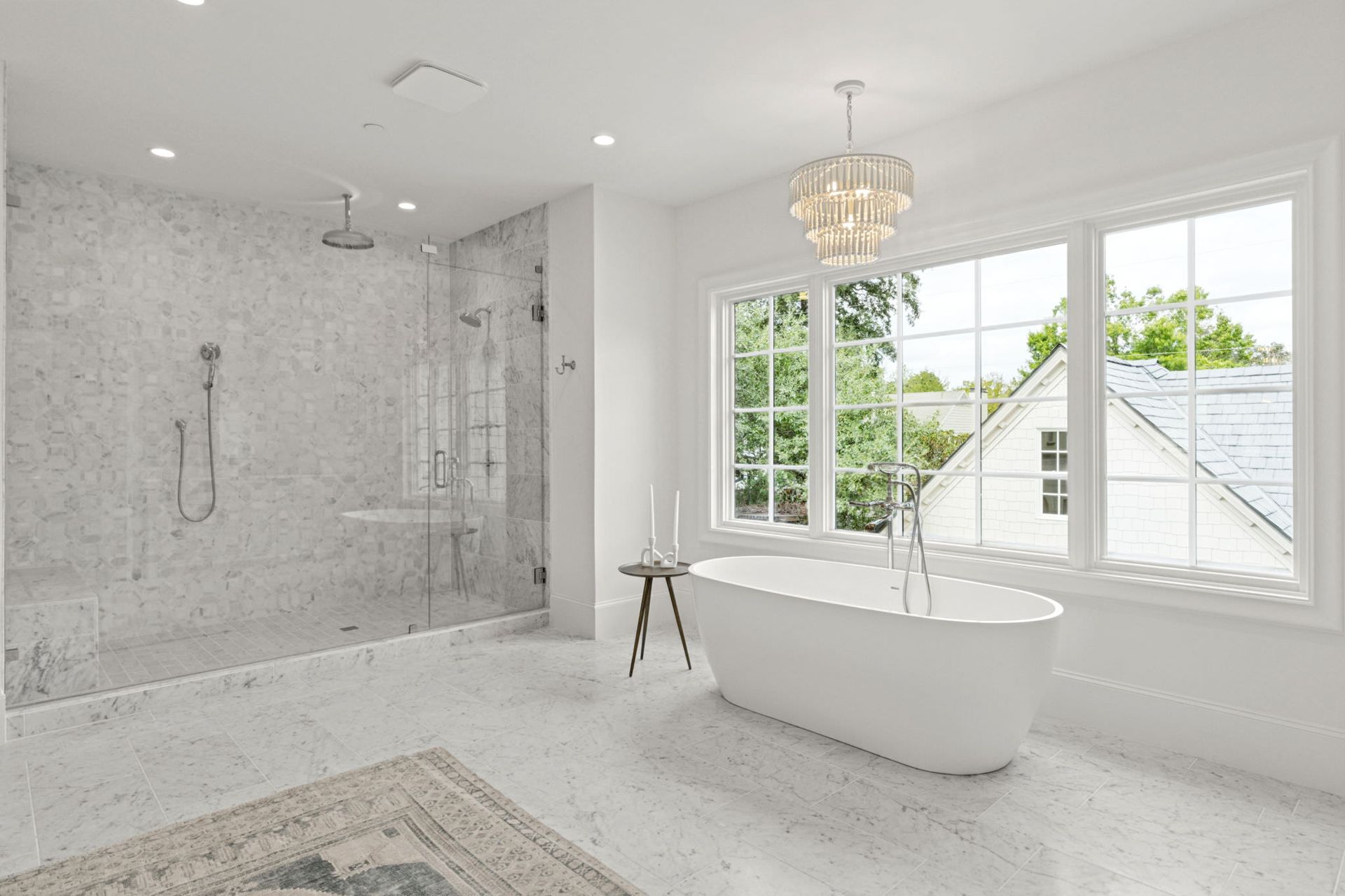 A bathroom with a tub , shower , and window.