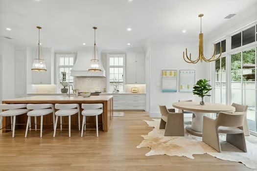 A kitchen and dining room in a house with a cowhide rug on the floor.