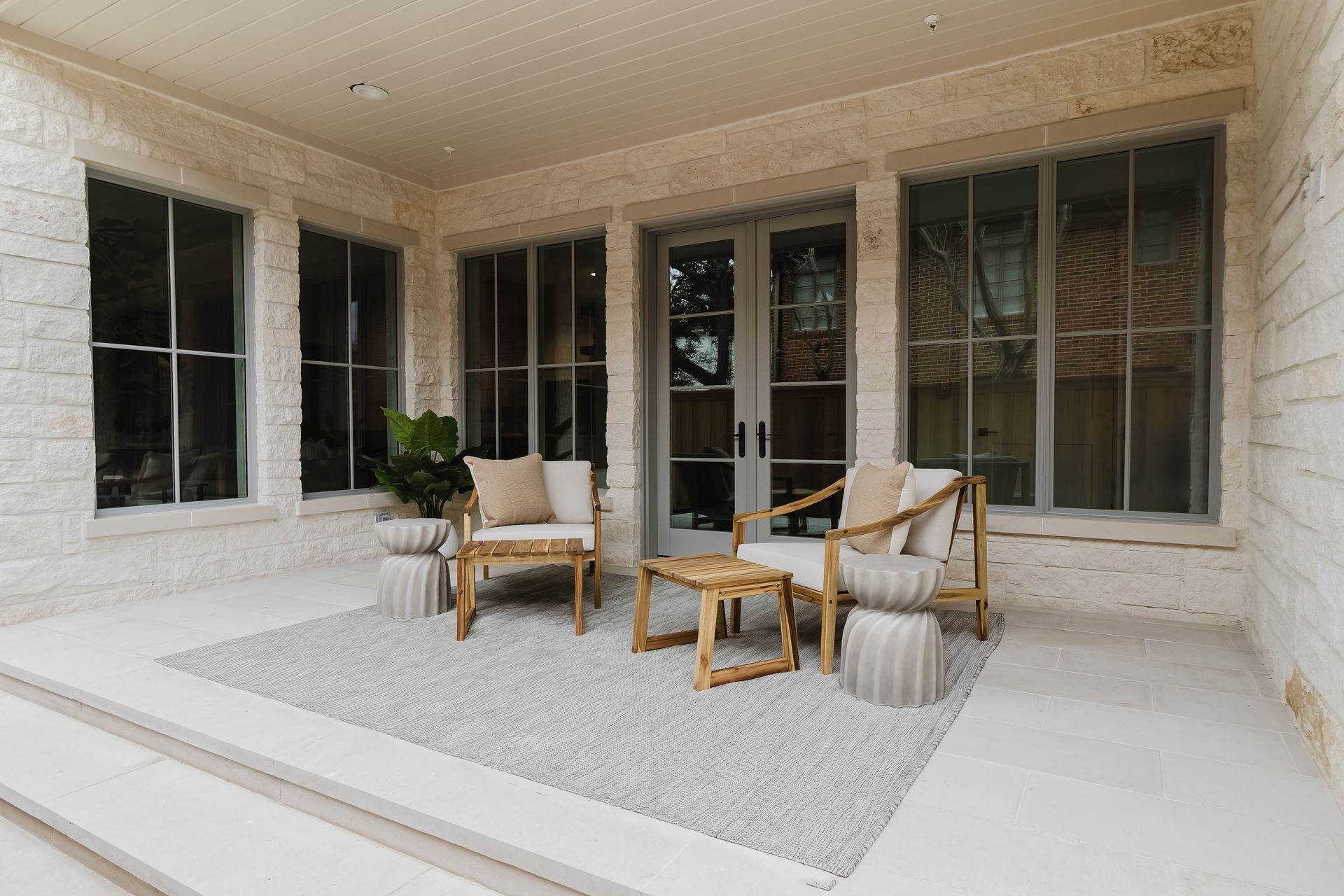 There is a patio with chairs and a table on it.