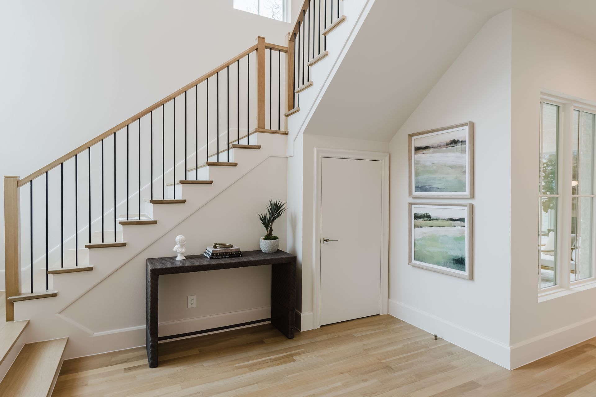 A staircase in a house with a table underneath it.