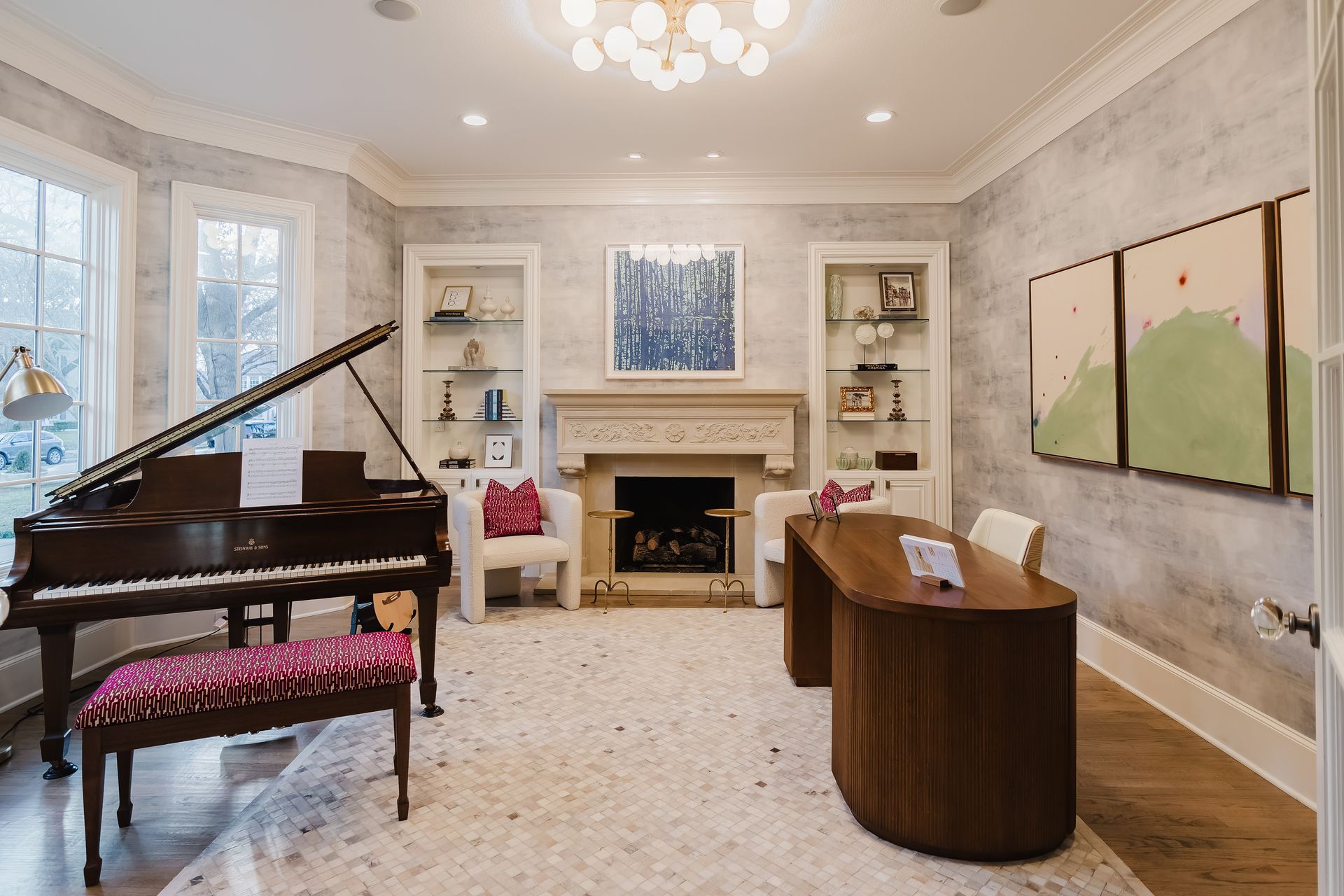 A living room with a piano , desk and fireplace.