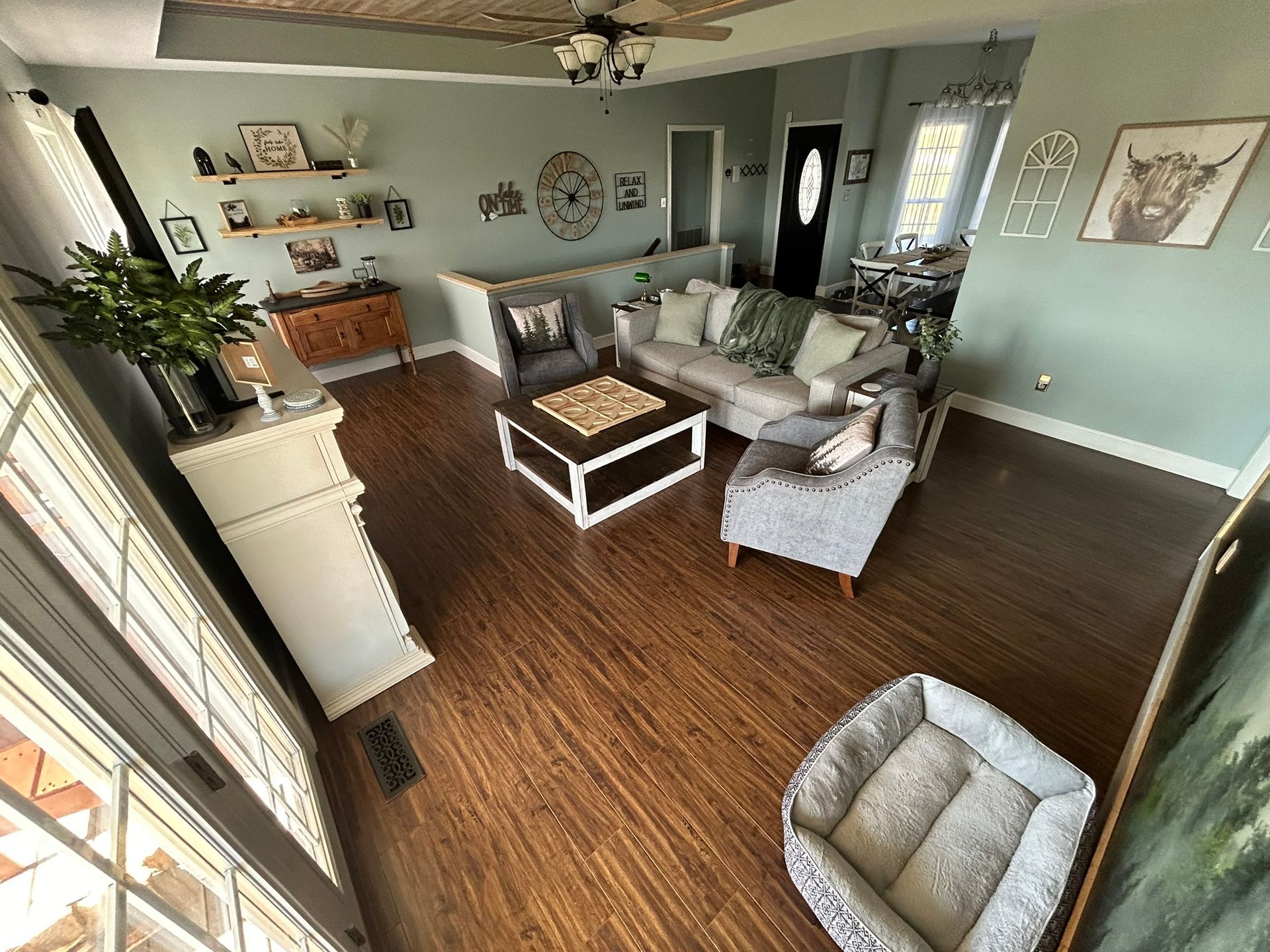 An aerial view of a living room filled with furniture and a dog bed.
