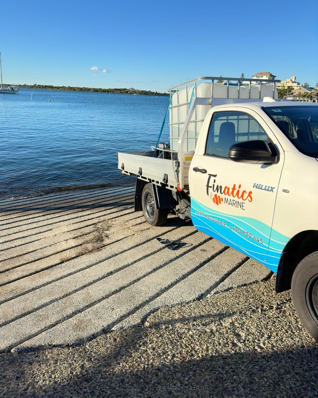 A Truck is Parked on a Gravel Road Next to a Body of Water — Finatics Marine in Macquarie, NSW