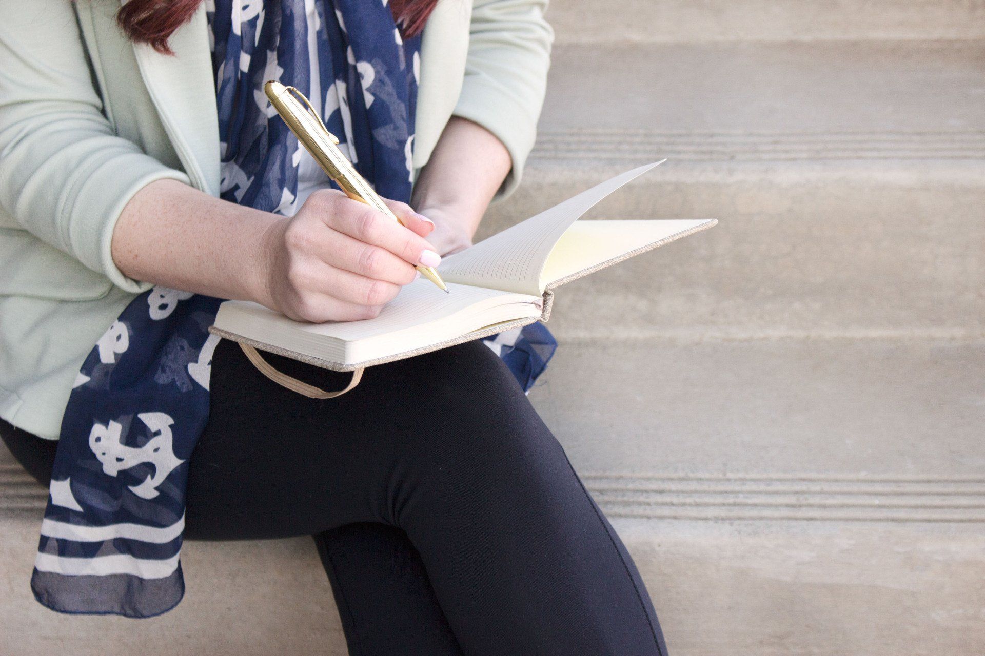 Woman writing in planner