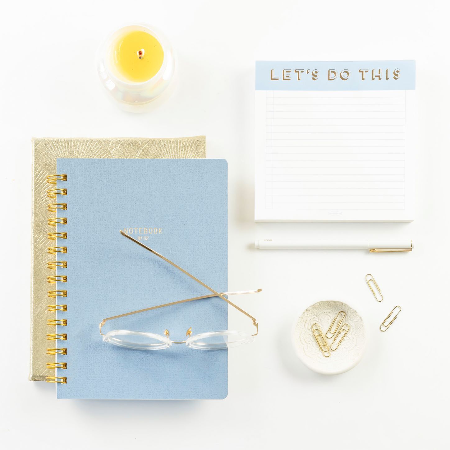 Notepads, candle, glasses, paperclips_Primer & Scout_How to Become a Virtual Assistant