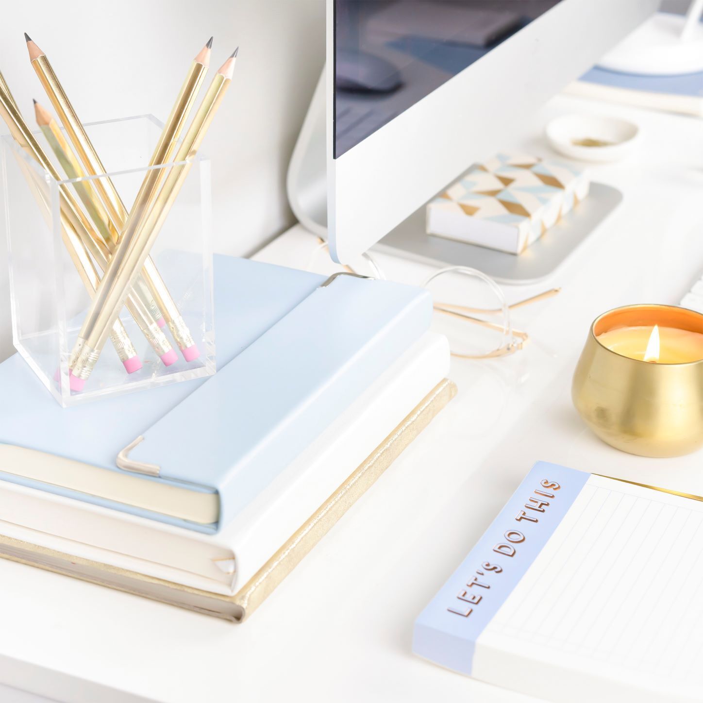 Notepads, desktop, pencils, candle, glasses_Primer & Scout_How to Become a Virtual Assistant