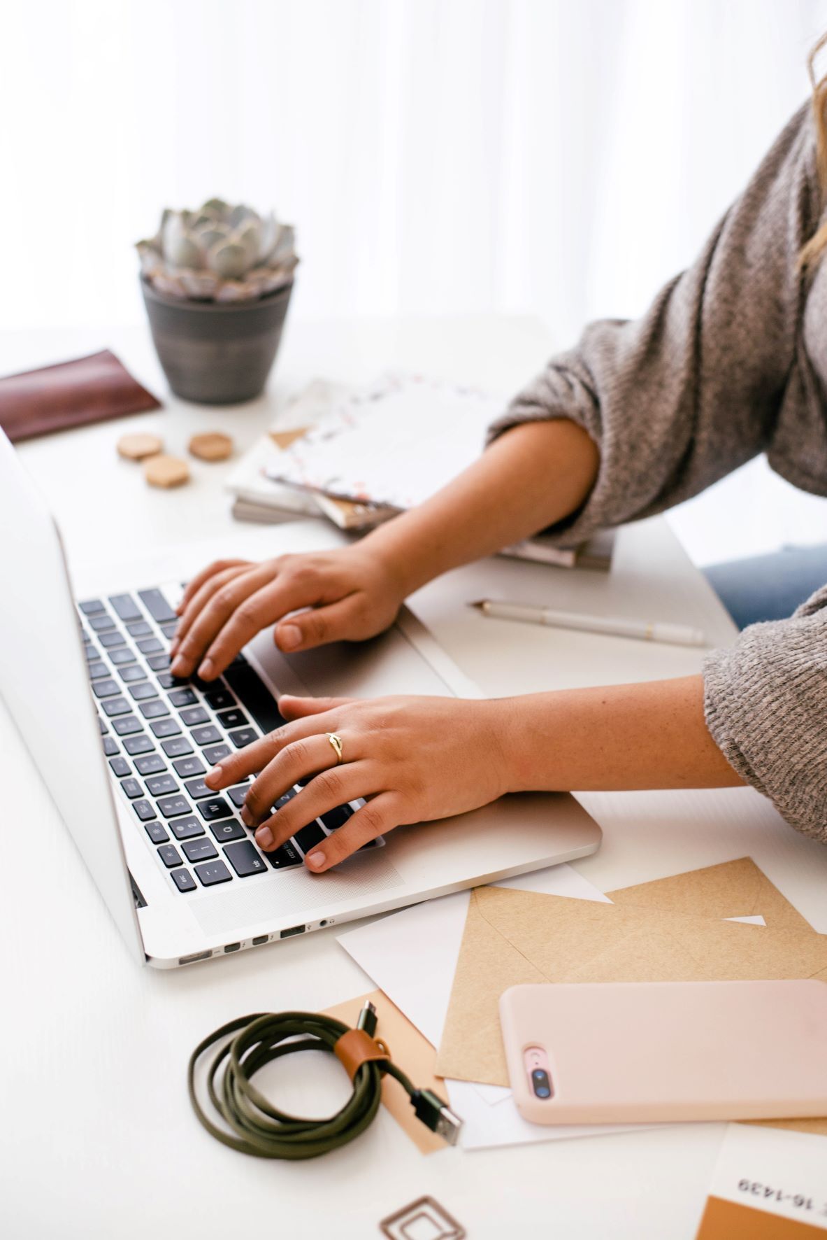 A virtual assistant typing a blog on computer for marketing plan