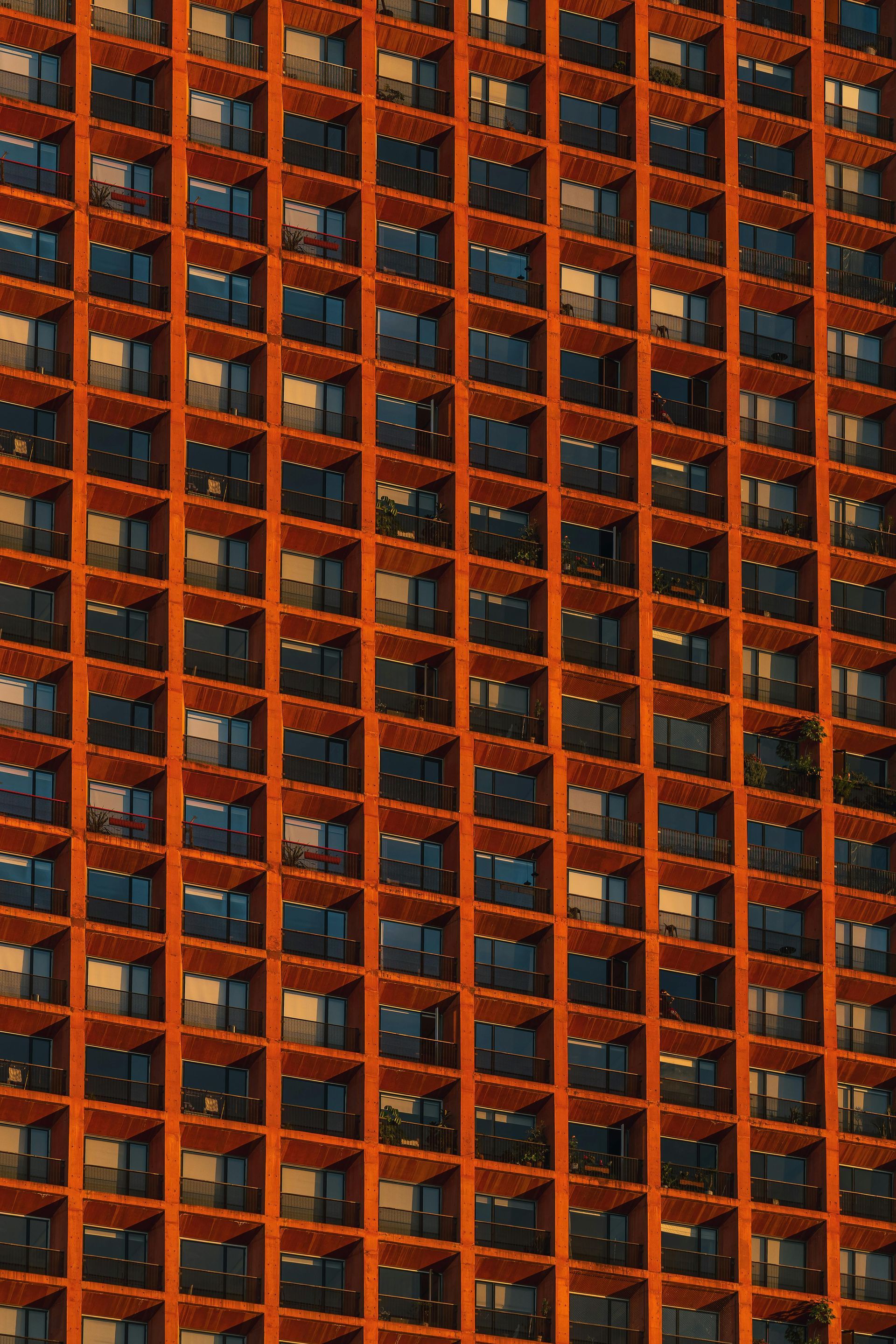Patterned orange building grid representing interconnected workplaces and data networks