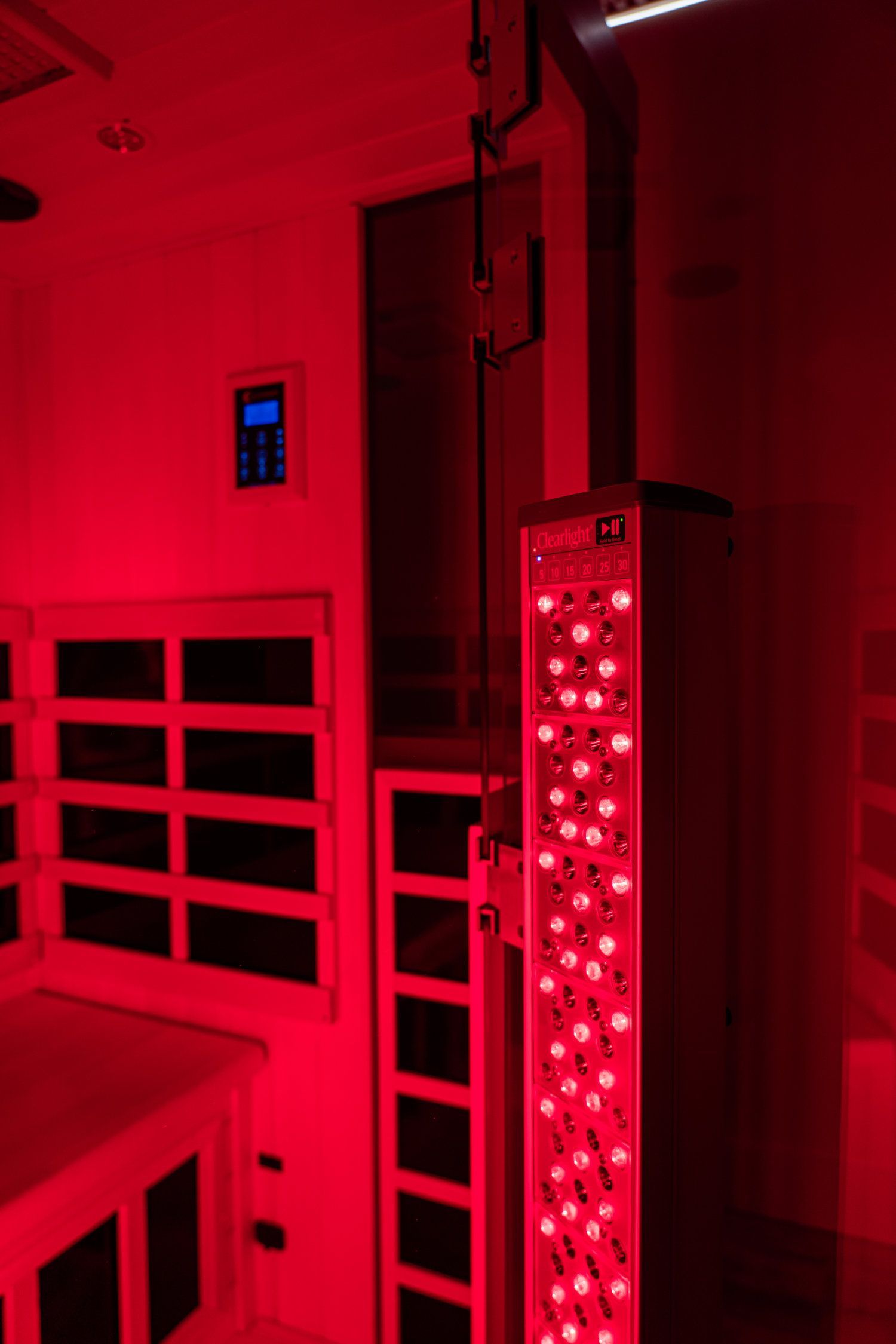 Red light therapy device inside a room, illuminating the space.