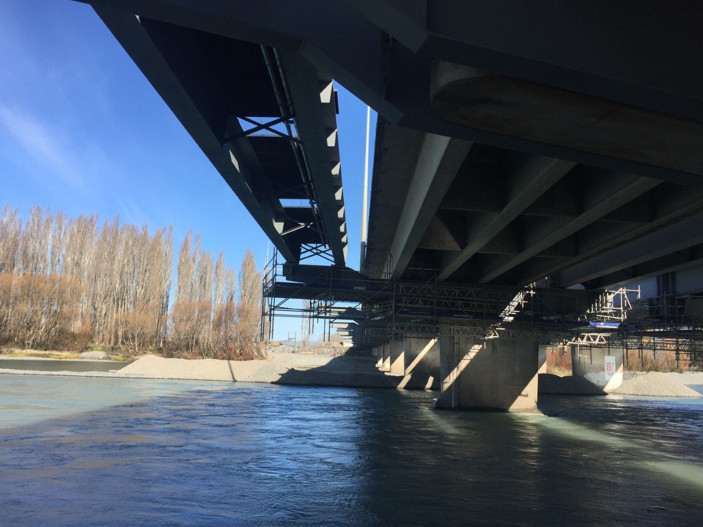 A bridge over a river with trees in the background