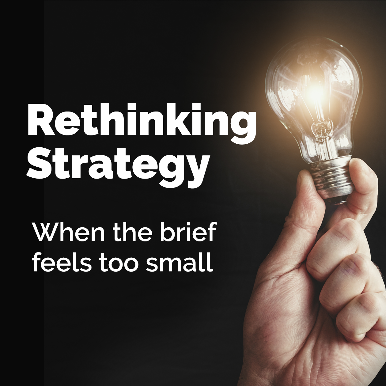 A hand is holding a light bulb that says rethinking strategy when the brief feels too small