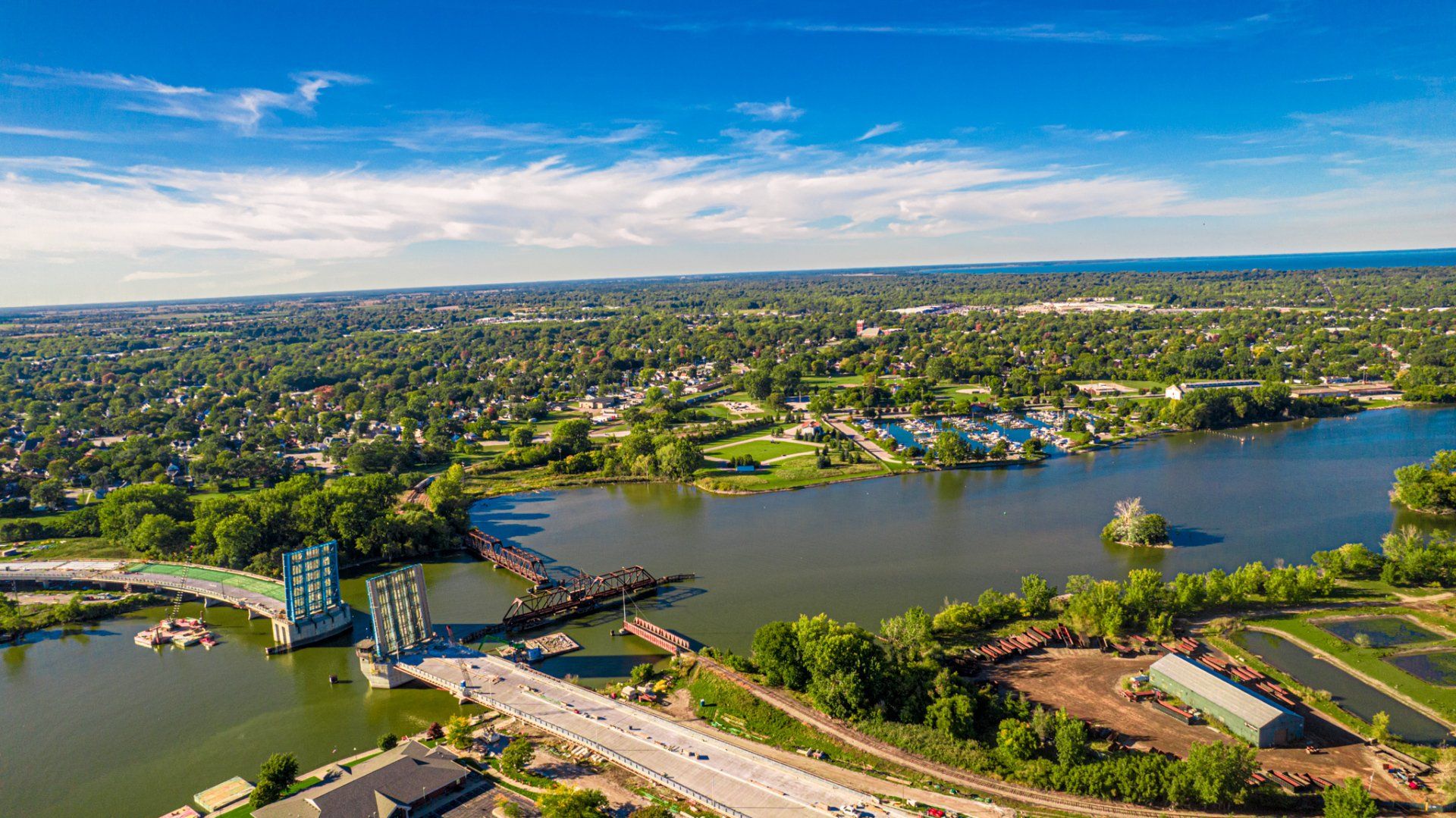 An aerial view of a bridge over a lake in a city.
