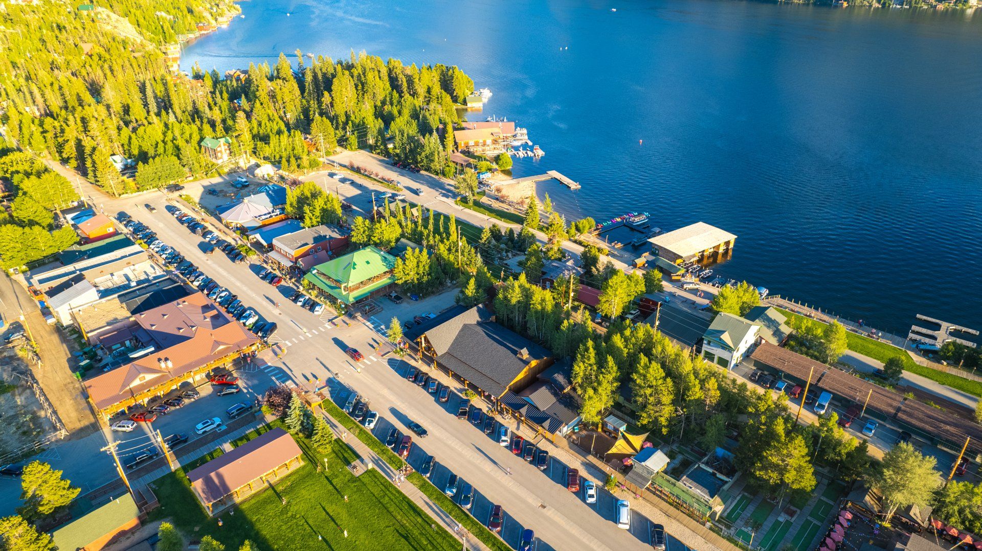 An aerial view of a small town next to a lake.