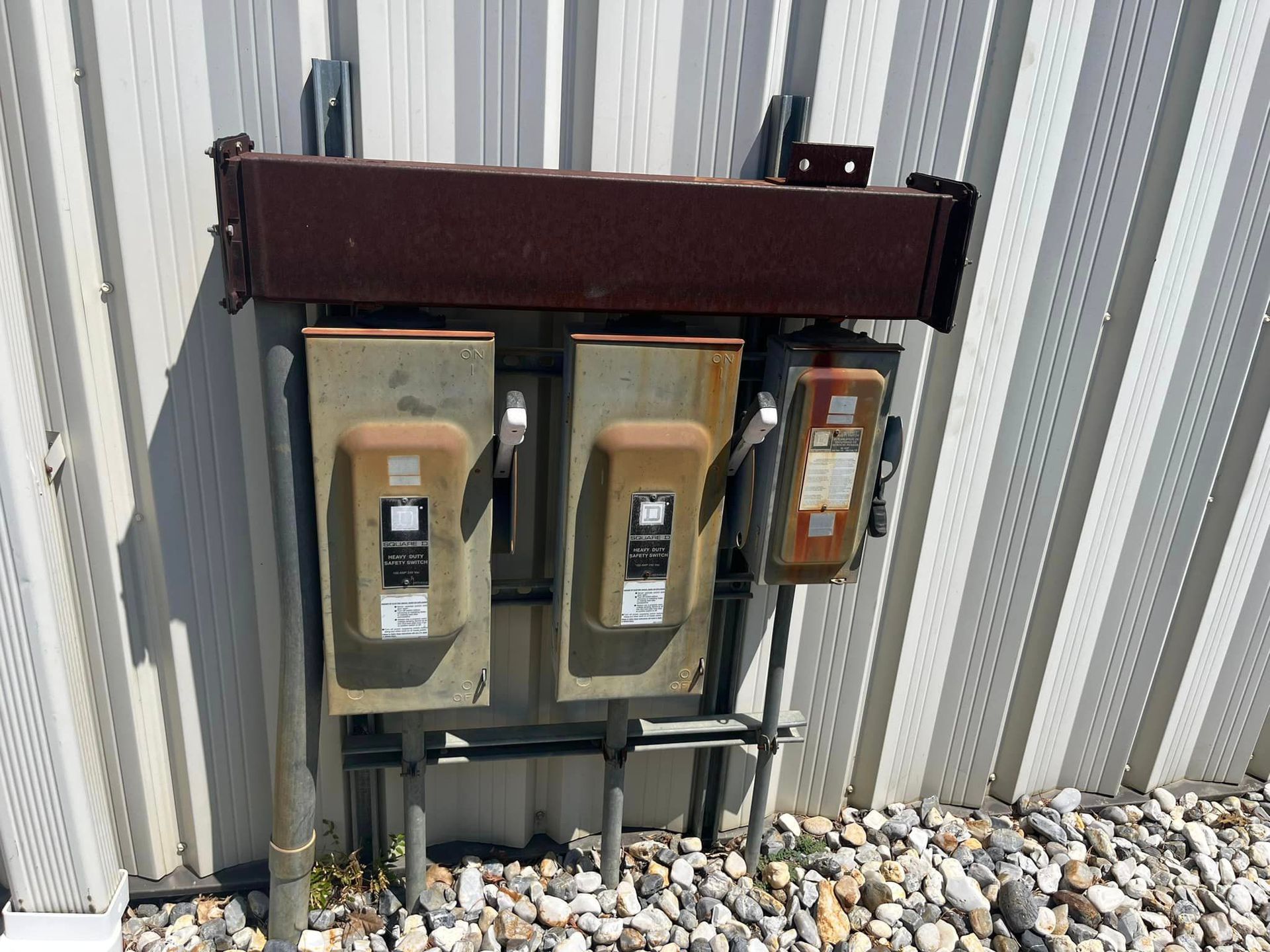 A row of electrical boxes on the side of a building