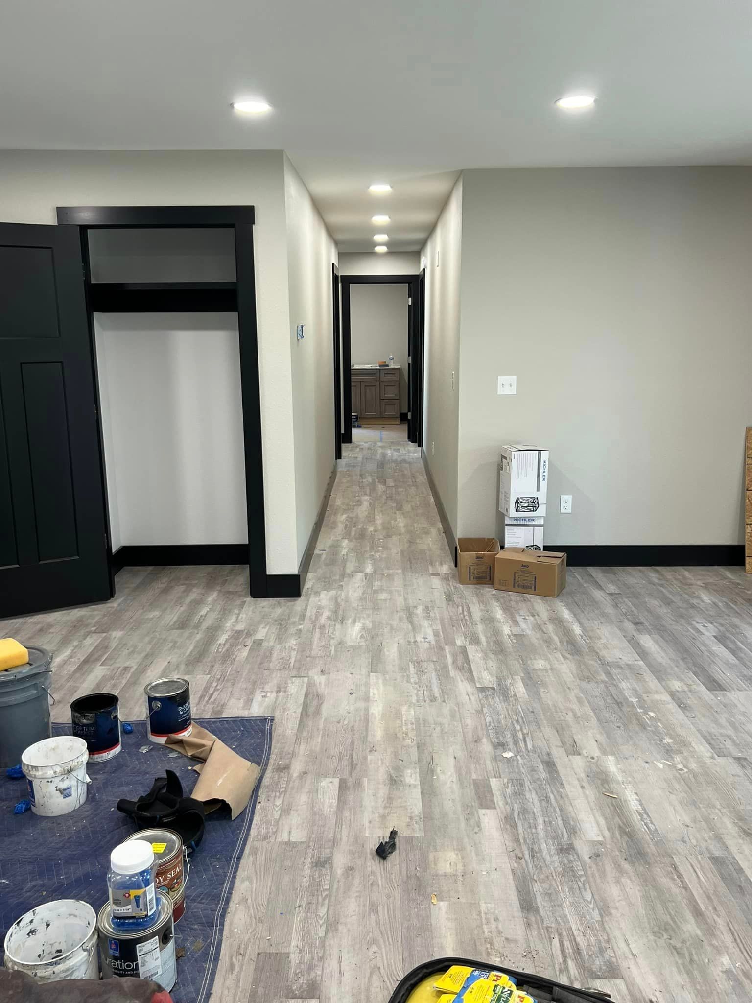 A hallway in a house that is being painted.
