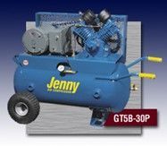 A blue air compressor with wheels is sitting on top of a table.
