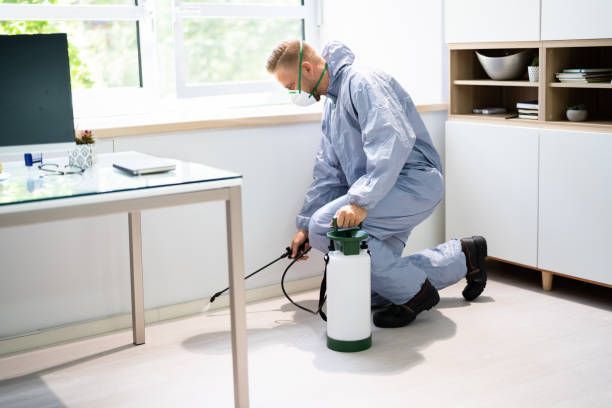 A person in protective gear kneeling on the floor