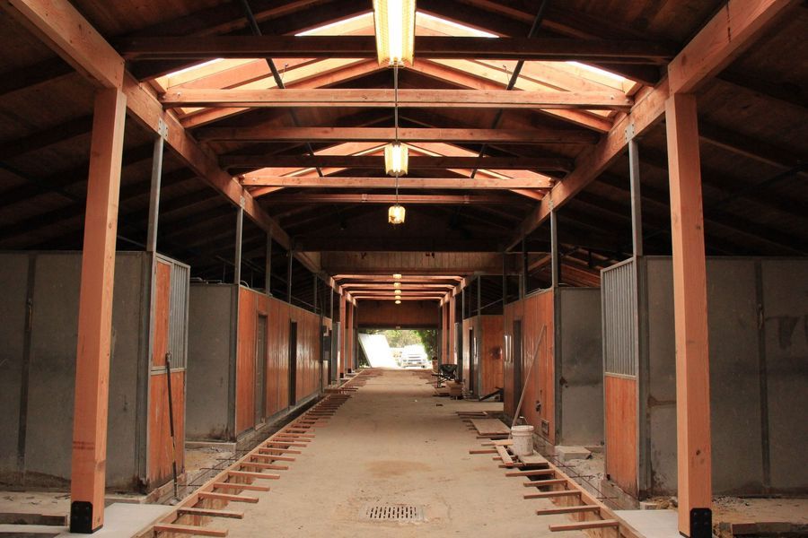 A long hallway with wooden beams and a light hanging from the ceiling