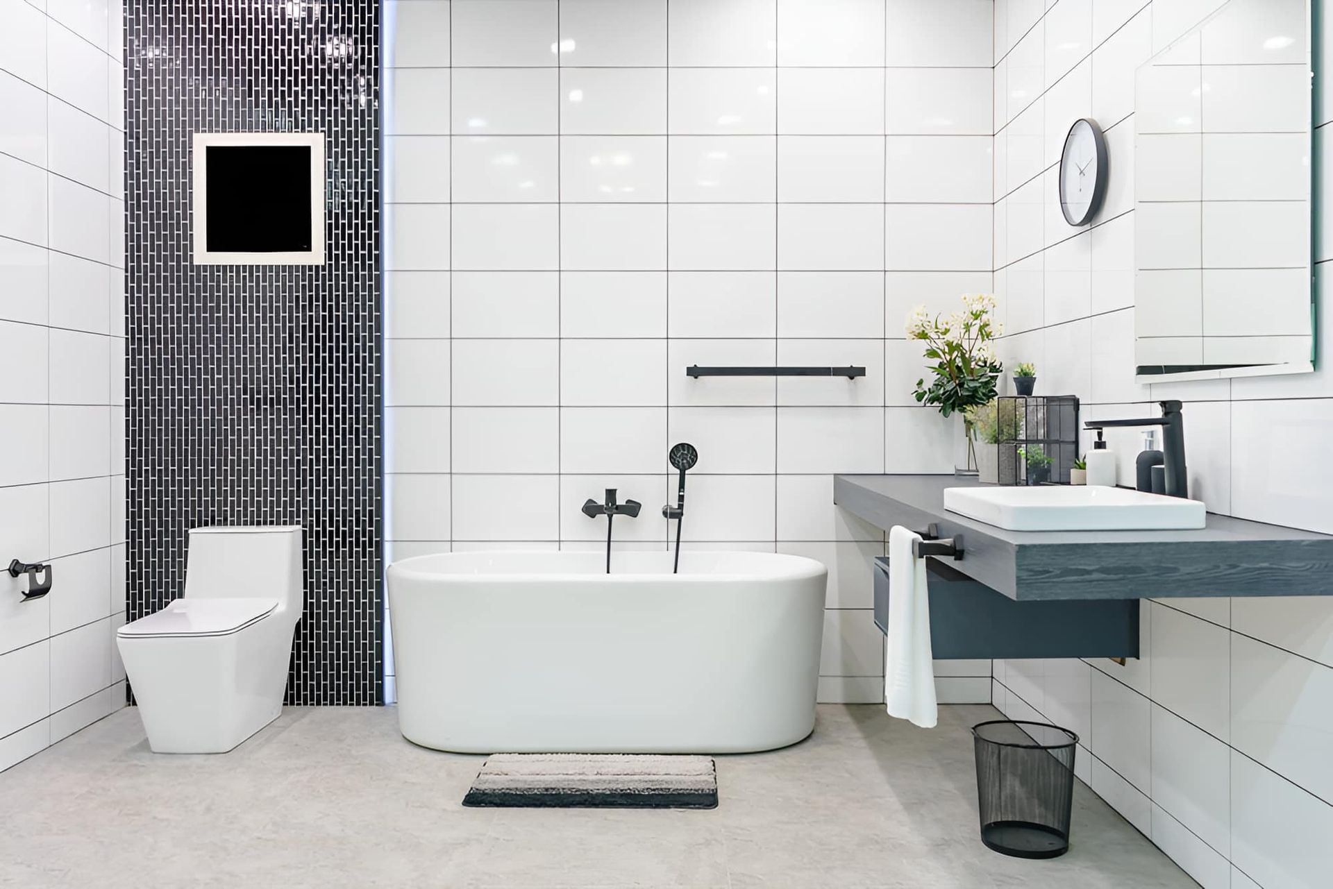 A Bathroom With A Bathtub , Toilet , Sink And Mirror — McGrath Builders & Associates In Lavington, NSW