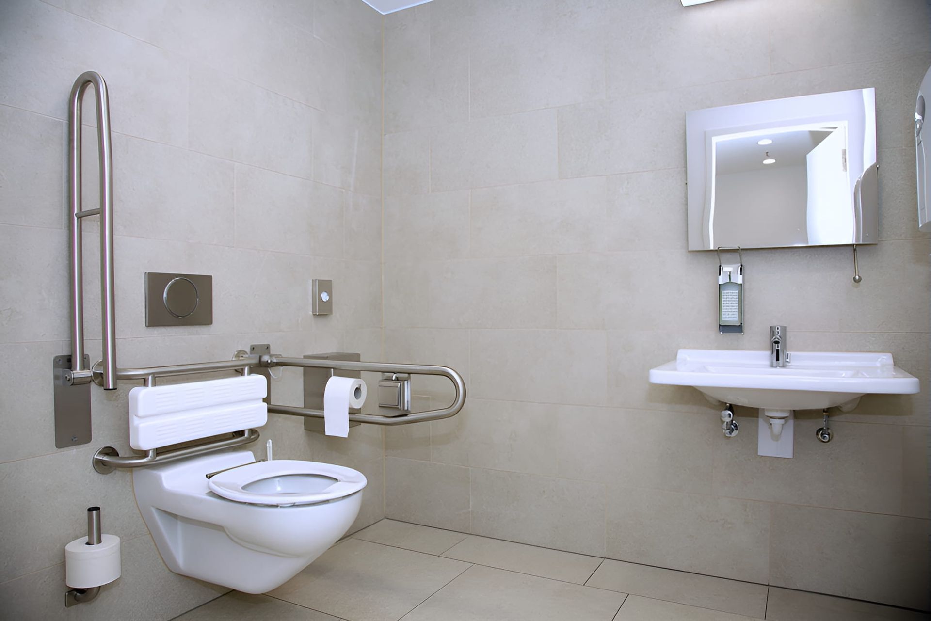 A Bathroom With A Toilet , Sink And Mirror — McGrath Builders & Associates In Lavington, NSW