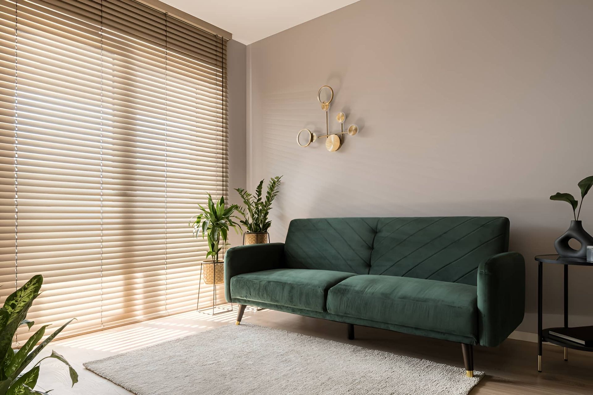 A Living Room With A Green Couch And Blinds On The Windows — McGrath Builders & Associates In Albury, NSW