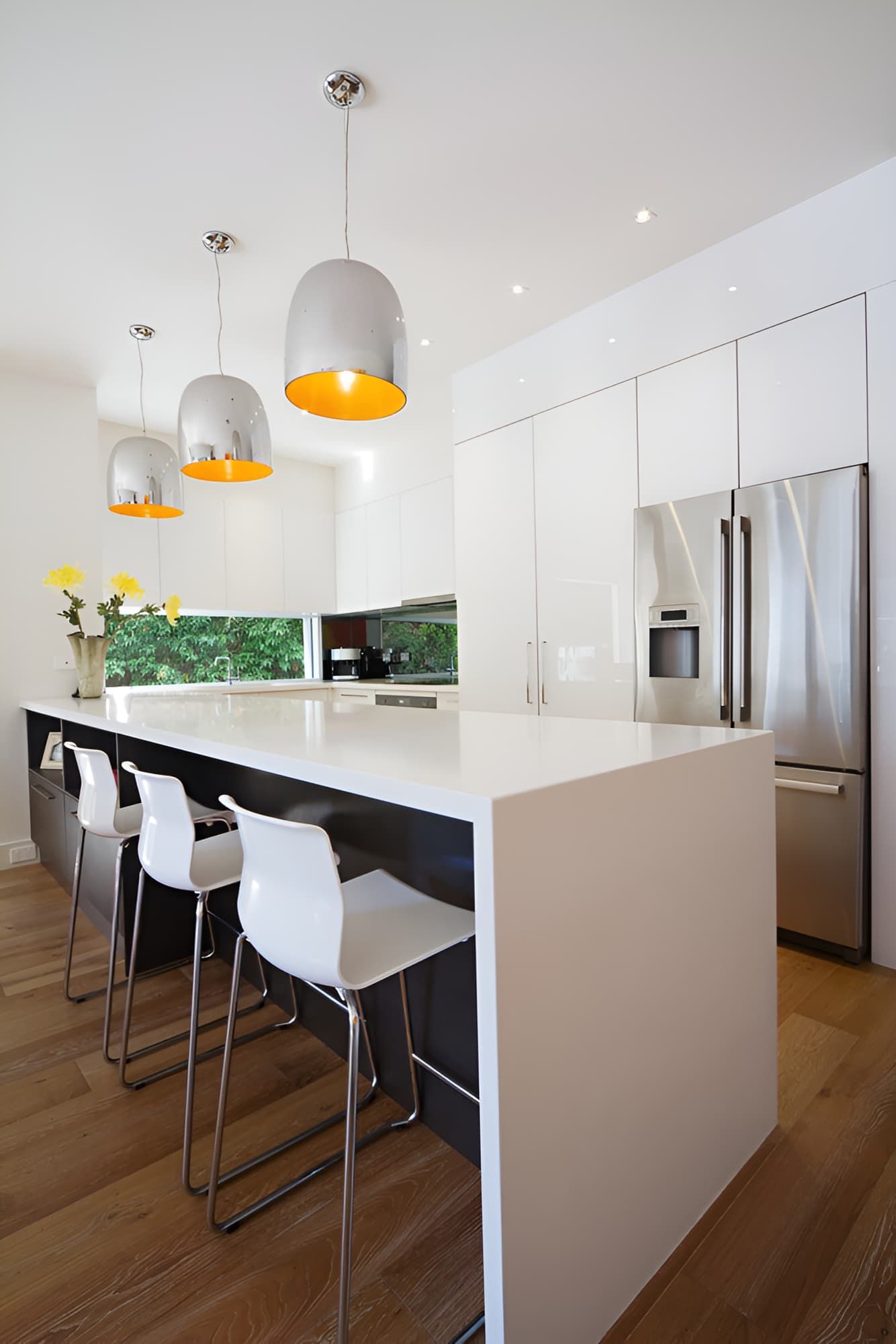 A Kitchen With White Cabinets And Stainless Steel Appliances — McGrath Builders & Associates In Lavington, NSW