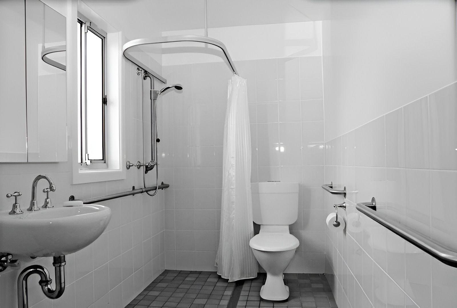 A Bathroom With A Toilet A Sink And A Window — McGrath Builders & Associates In Lavington, NSW