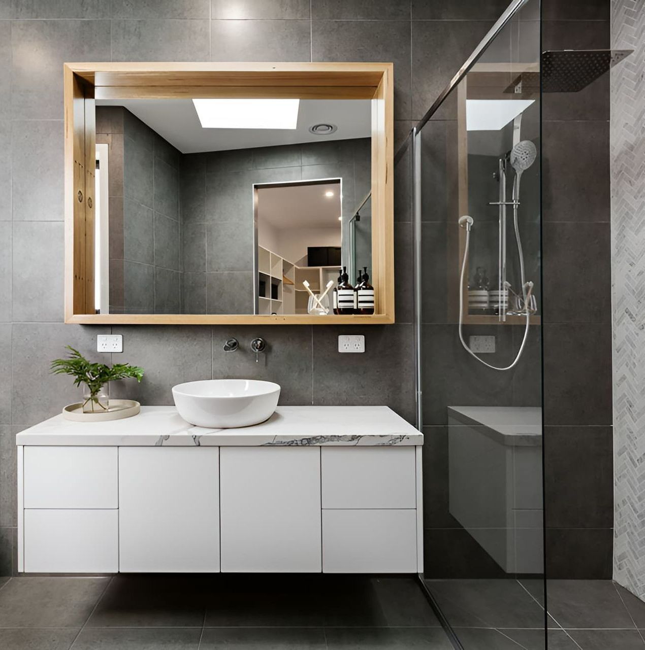 A Bathroom With A Sink A Mirror And A Walk In Shower — McGrath Builders & Associates In Lavington, NSW