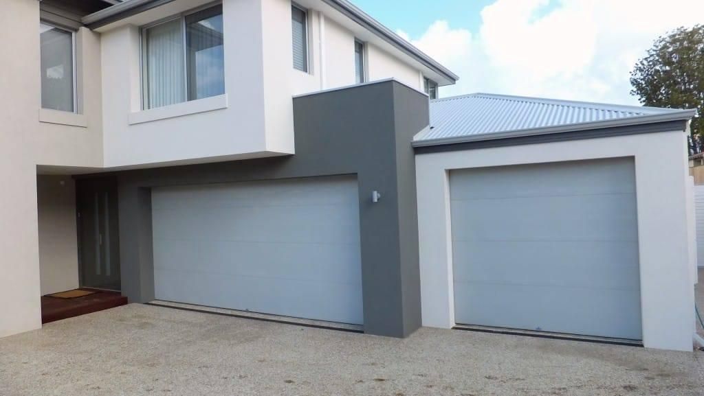 A House With Two Garage Doors and a Driveway — P & D Garage Doors in Taree, NSW