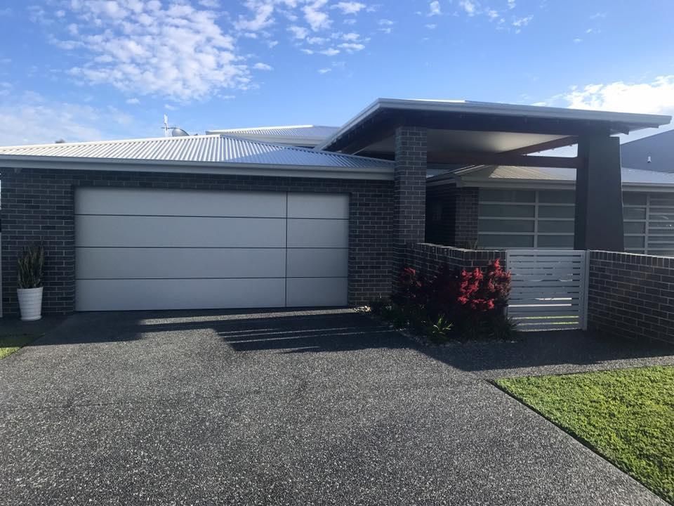 A Modern House With a Large Garage — P & D Garage Doors in Taree, NSW