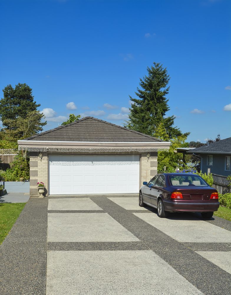 Suburban Driveway Leading To Light Brick Garage