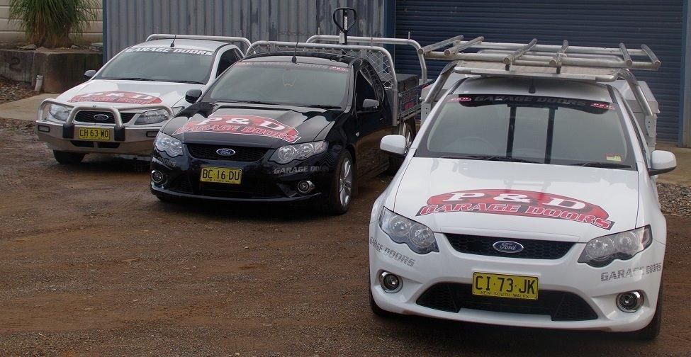 Three Ford Cars Are Parked Next to Each Other — P & D Garage Doors in Taree, NSW