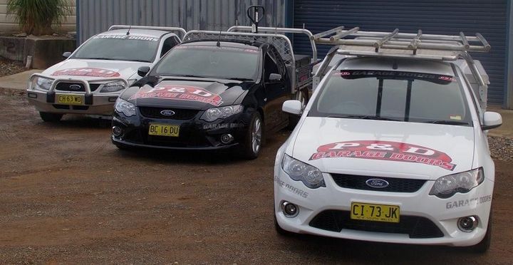 Three Ford Cars Are Parked Next to Each Other — P & D Garage Doors in Taree, NSW