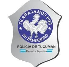 Argentinian Police badge: silver shield with blue circular emblem, white rooster, text: 