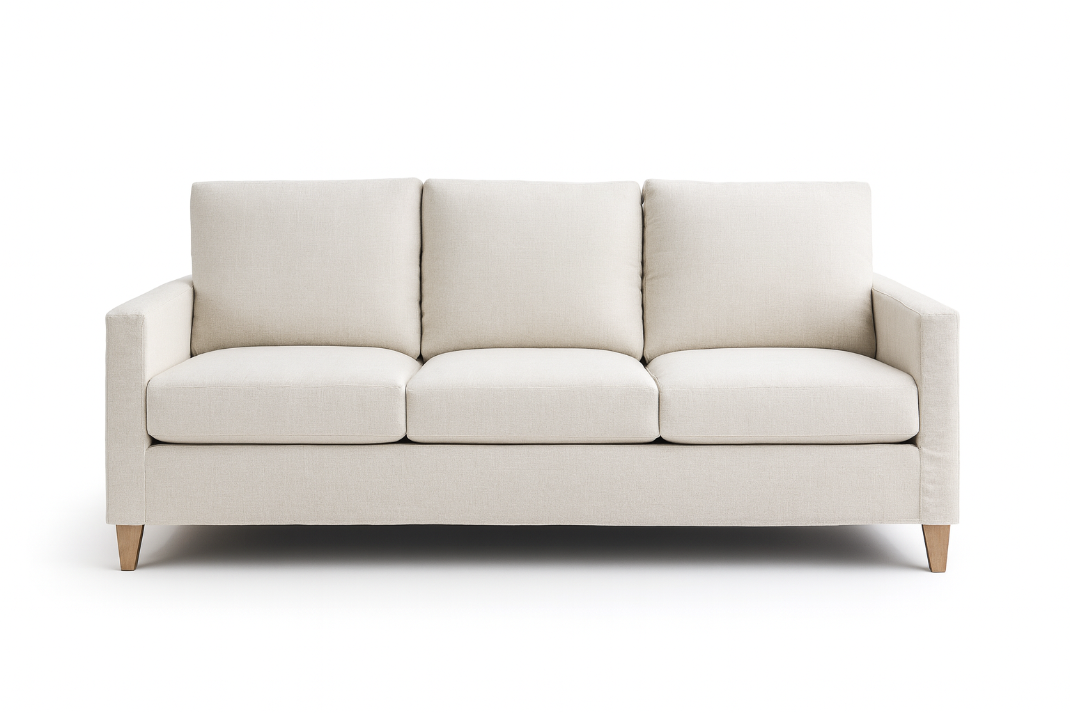 Cream-colored three-cushion sofa with square arms and wooden legs, against a white background.