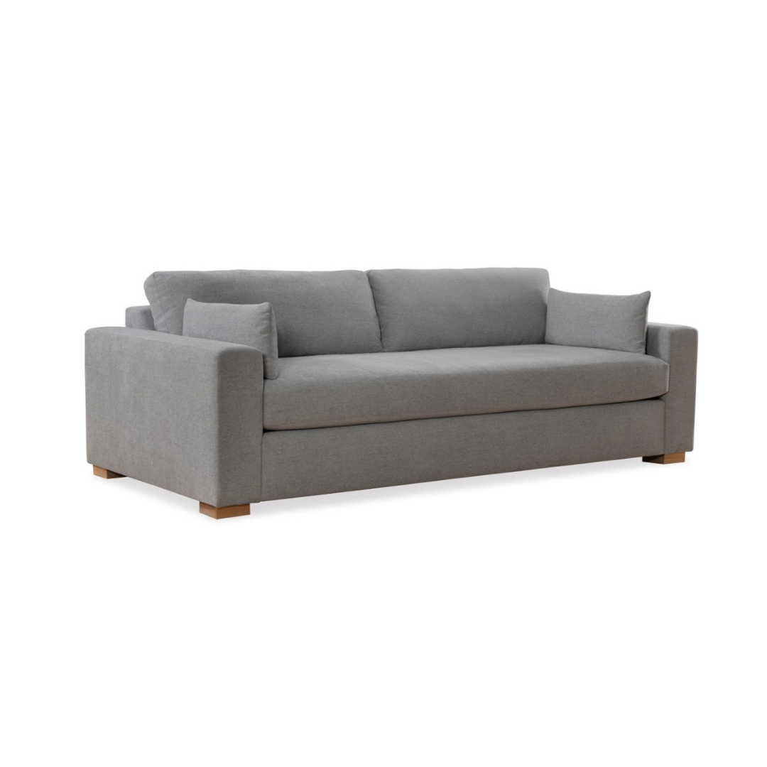 Gray upholstered sofa with two back pillows and two square side pillows, on a wood base.