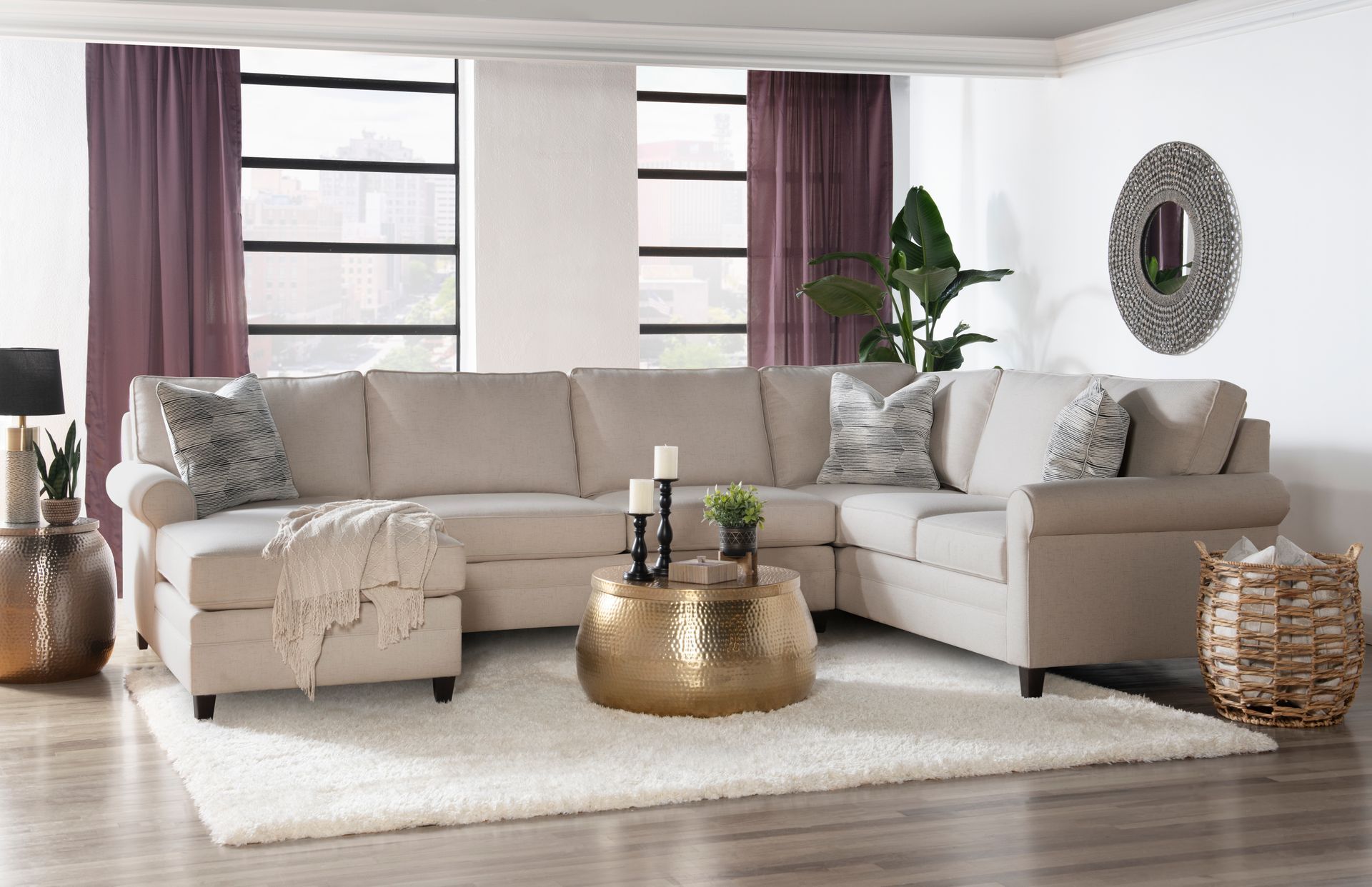 A modern living room with a sectional couch and a coffee table.