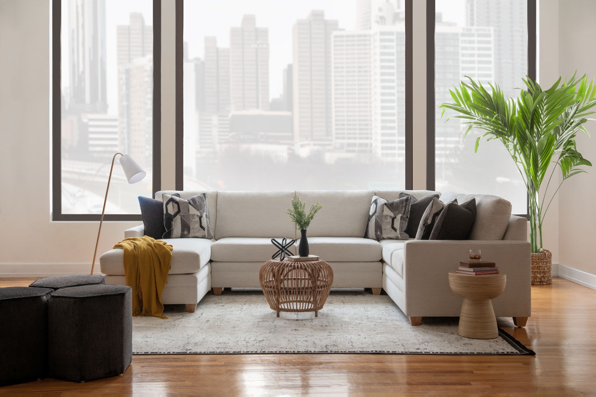 A living room with a large sectional couch and a coffee table.