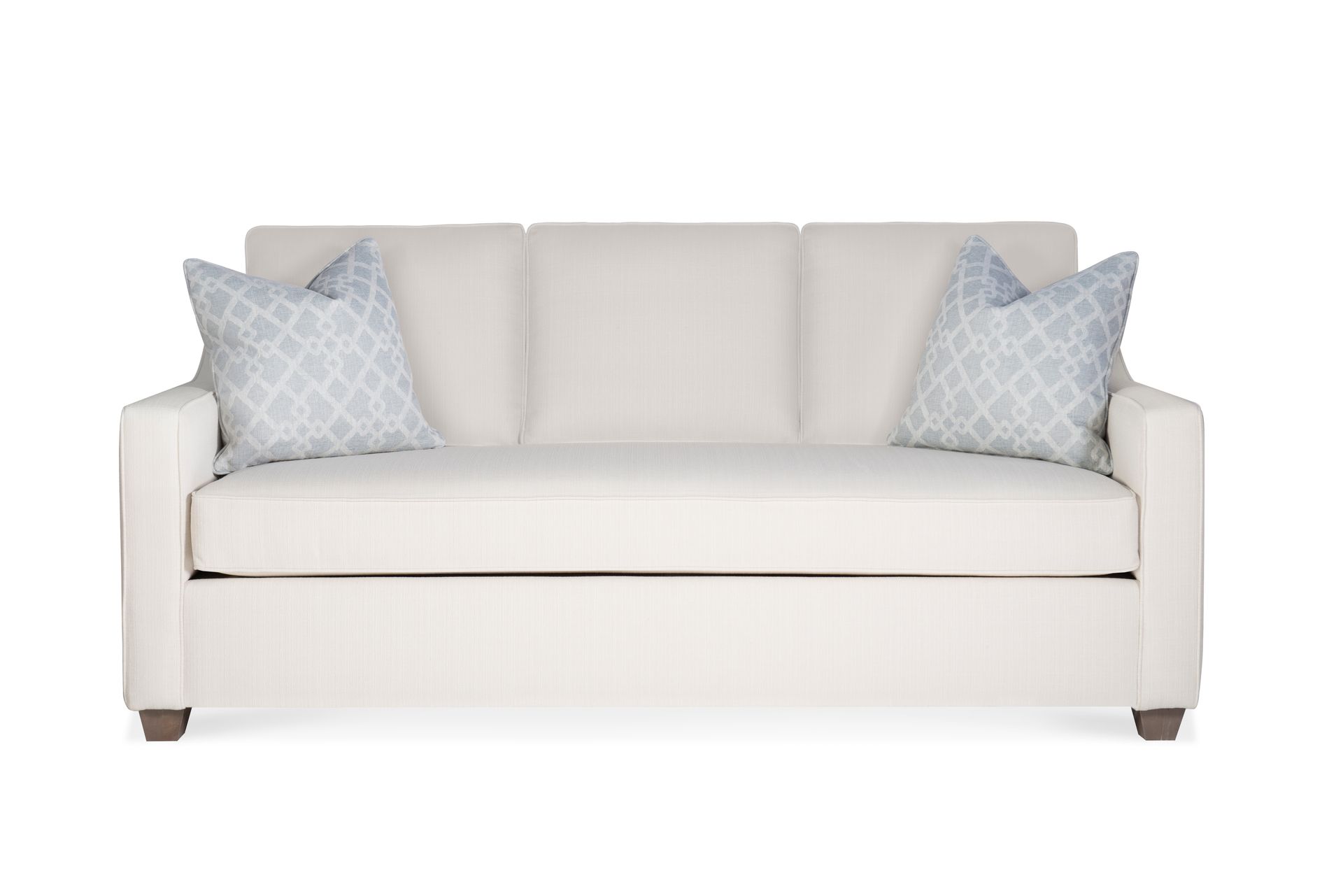 A white couch with two pillows on it on a white background.