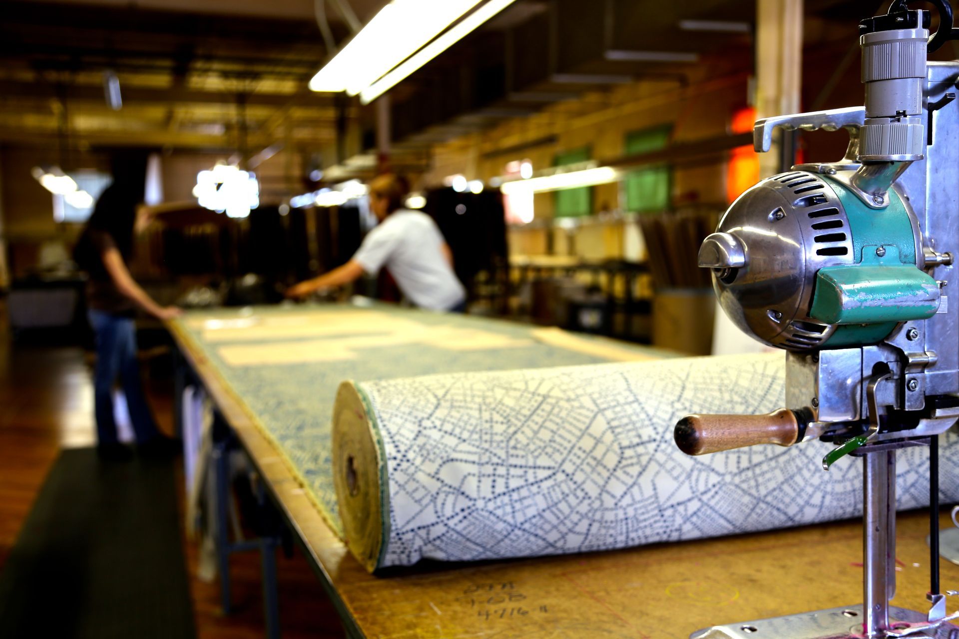 A sewing machine is sitting on a table in a factory