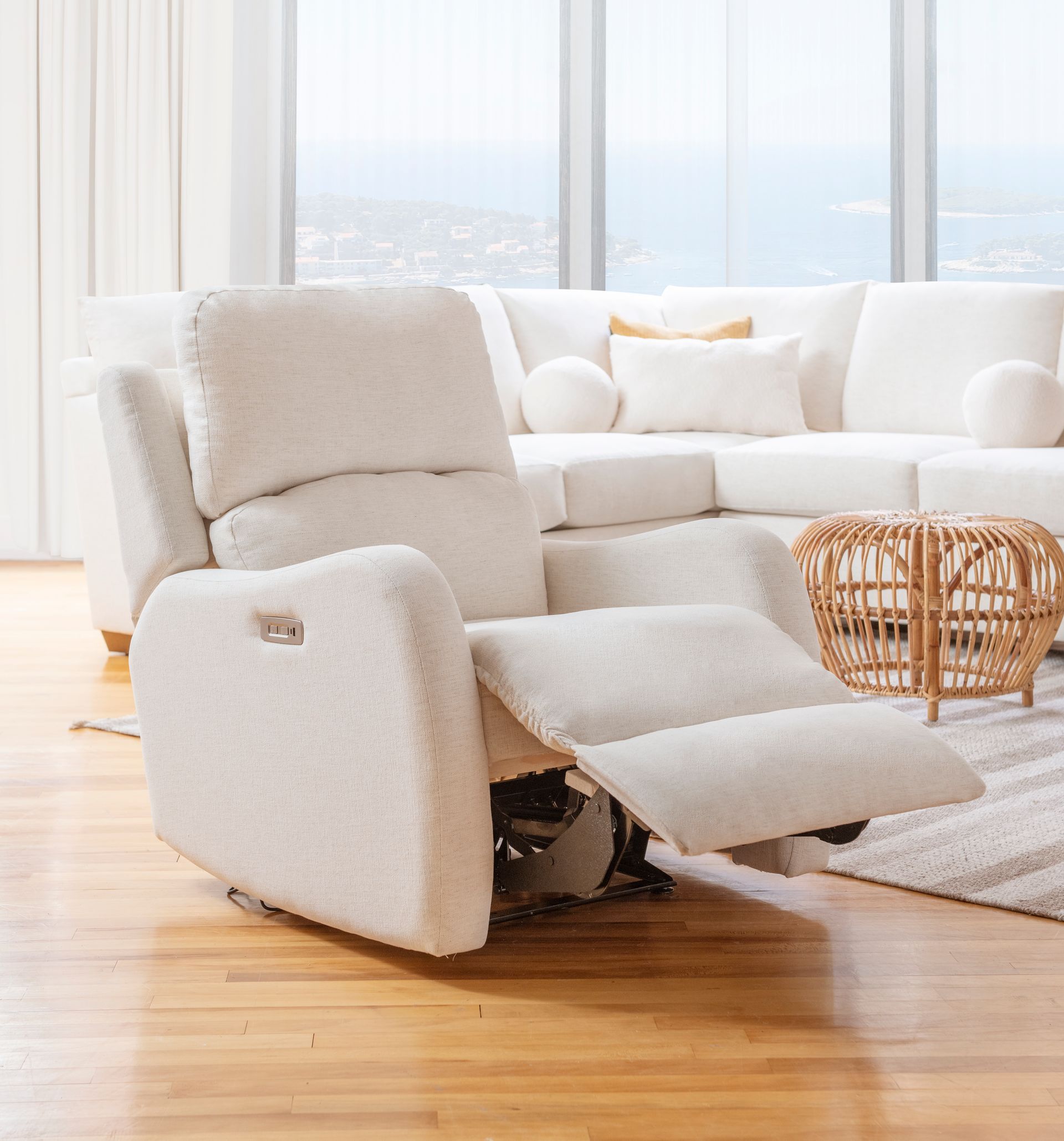 Custom recliner is sitting in a living room next to a white couch.