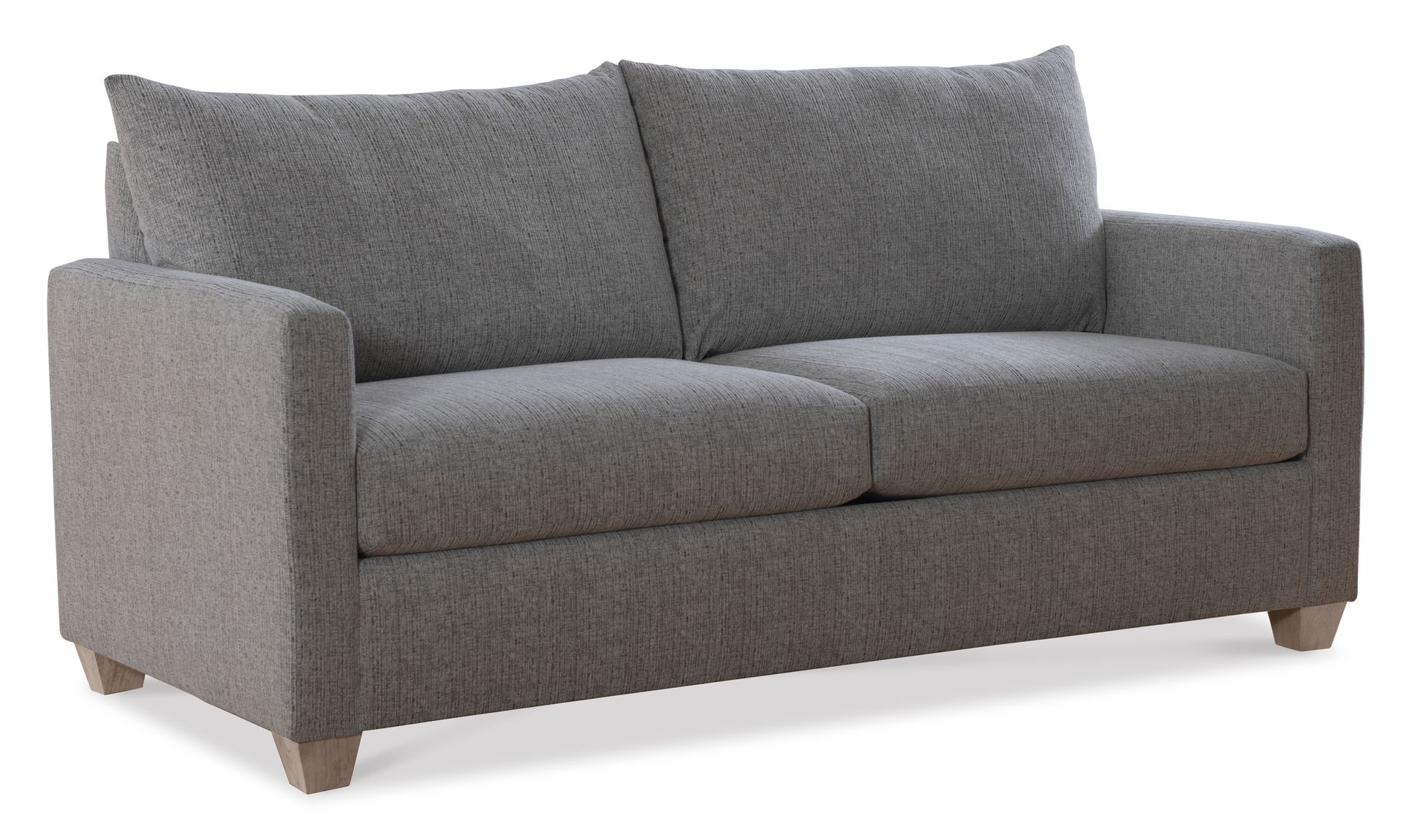 A grey couch is sitting on a white surface.