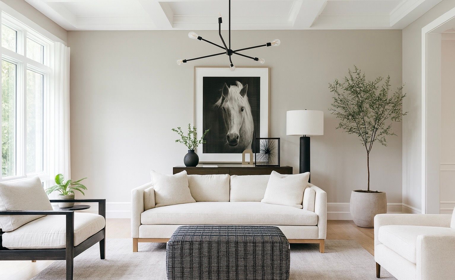 Living room with beige walls, white furniture, and a horse portrait.